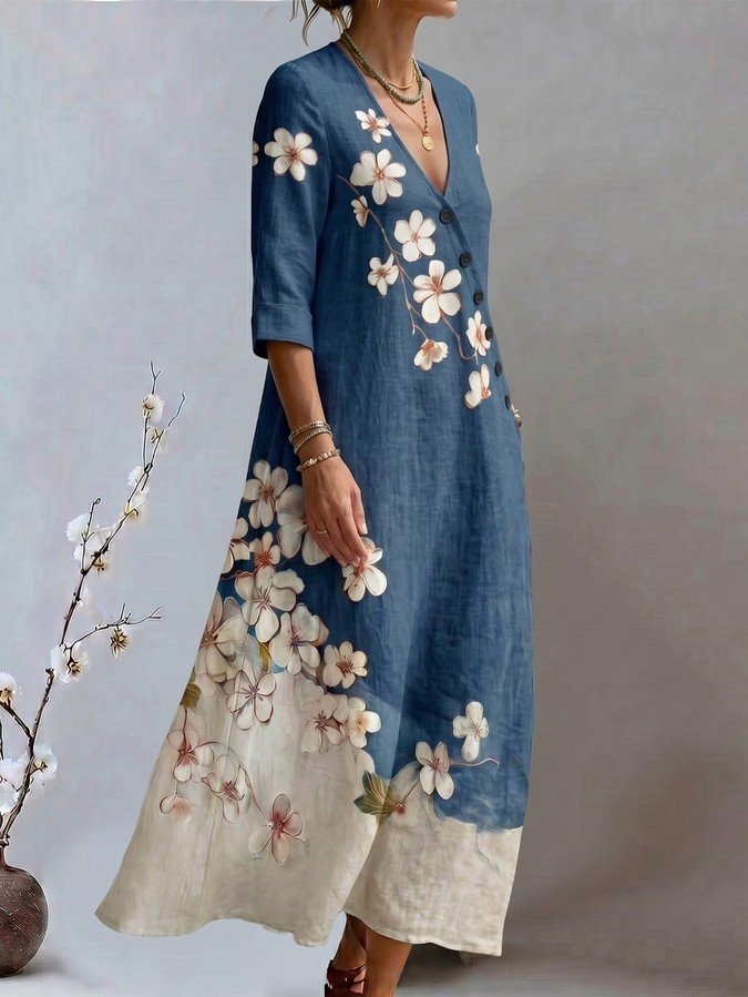 Front view of a blue floral print V-neck maxi dress with three-quarter sleeves.