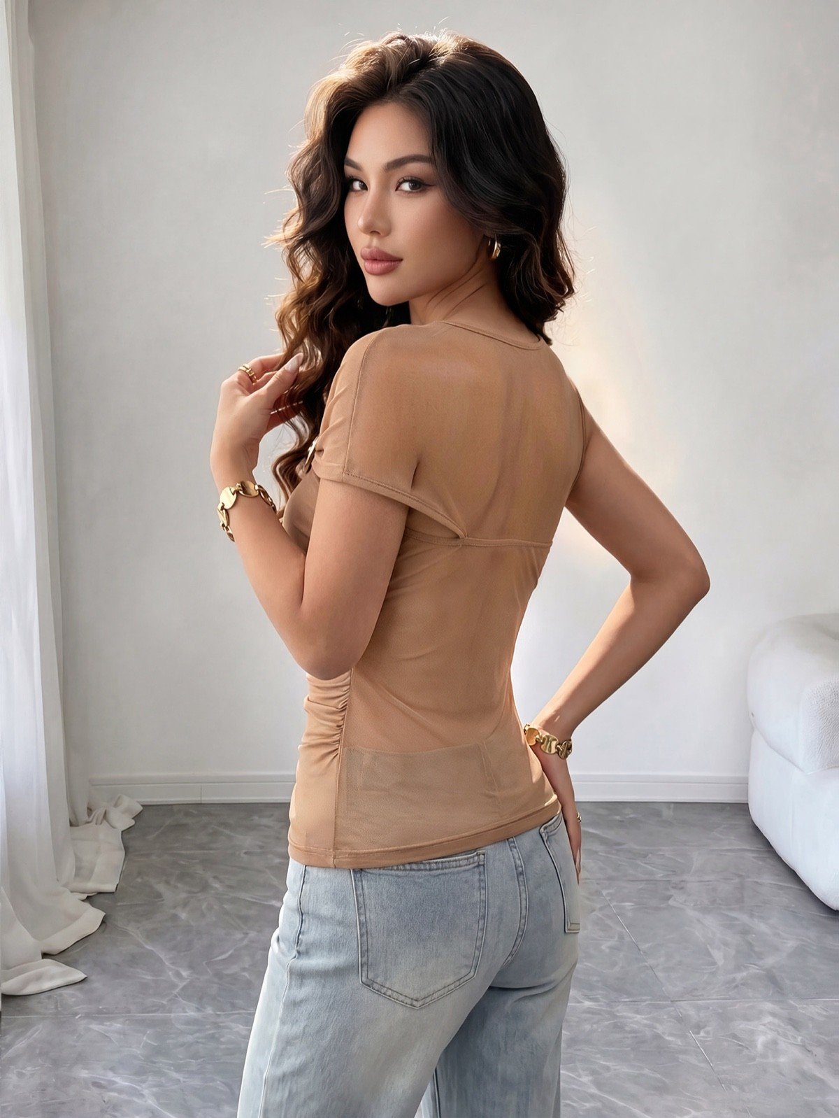 Back view of a camel mesh one-shoulder ruched top with polished ring detail.