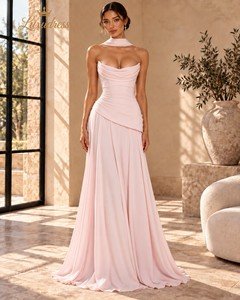 Front view of a blush pink strapless cowl neck evening gown with a fitted bodice, asymmetric draped waist and flowing skirt.