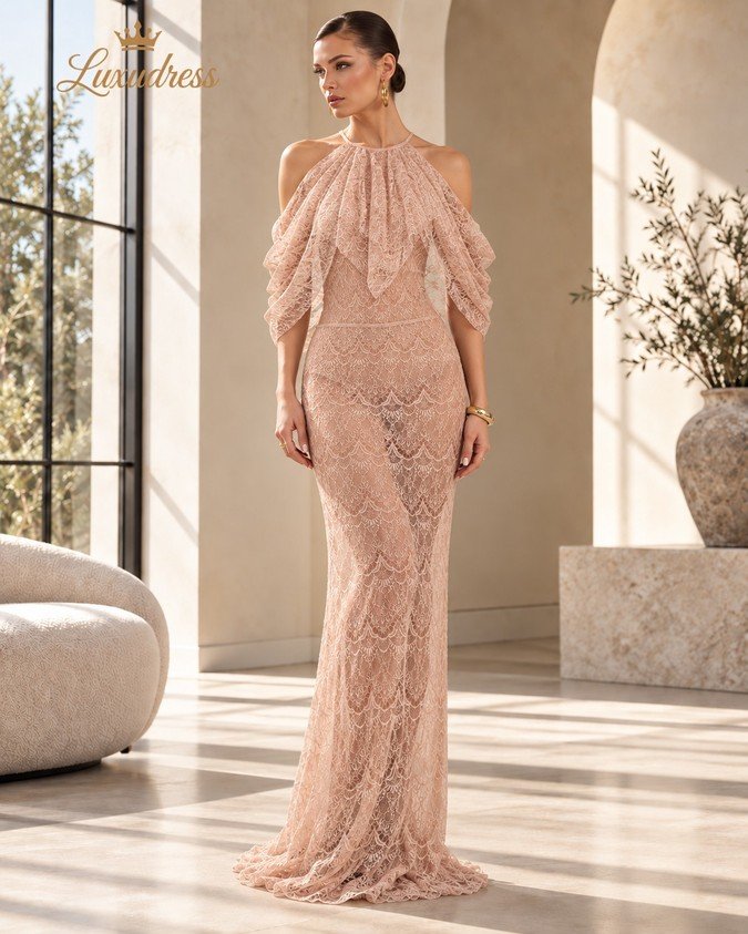 Front view of a blush pink halter lace evening gown with draped sleeves and a fitted floor-length silhouette.