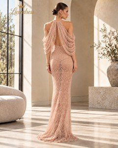 Back view of a blush pink halter lace evening gown showing an open back, draped shoulder panels and a floor-length skirt.