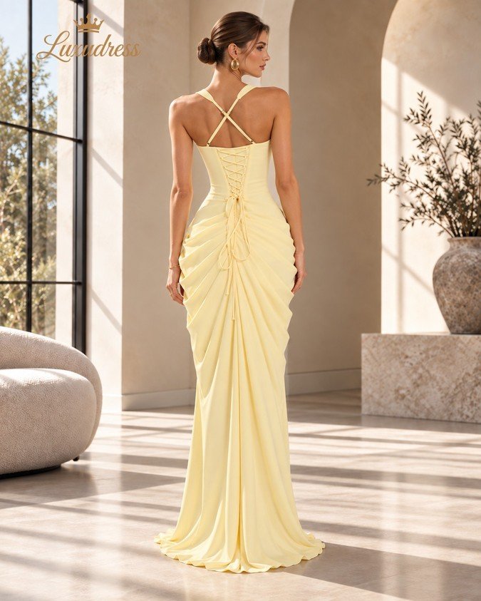 Back view of a butter yellow corset prom dress with crossed shoulder straps, lace-up fastening and gathered draping.