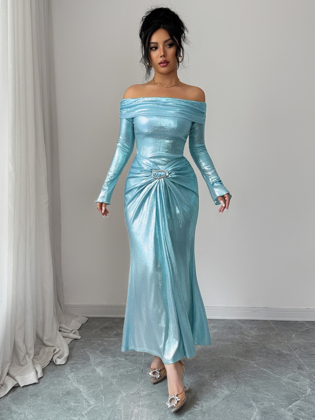 Front fit view of an ice blue metallic off-shoulder maxi dress with a ruched buckle waist.