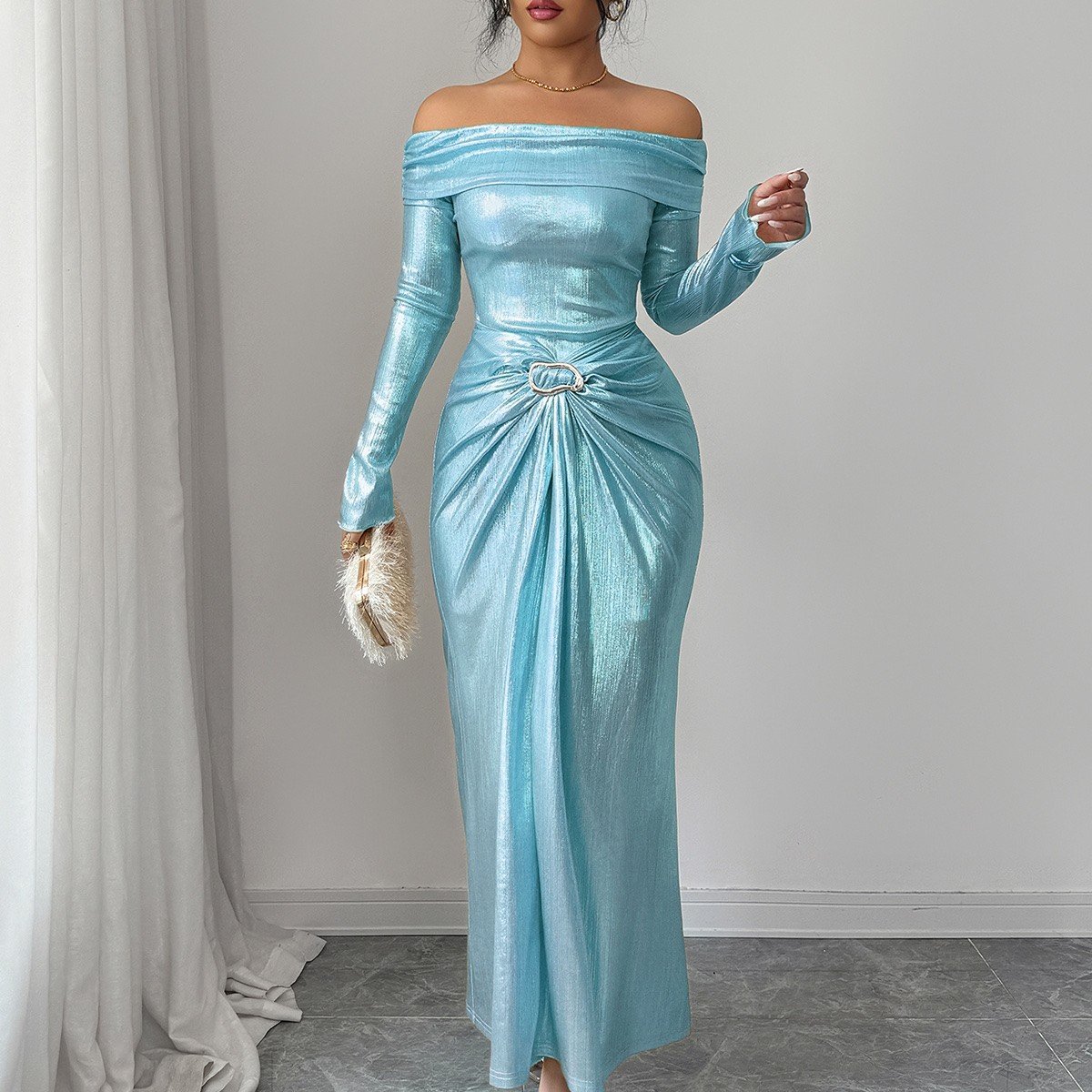 Full-length front view of an ice blue metallic off-shoulder maxi dress with a ruched buckle waist.