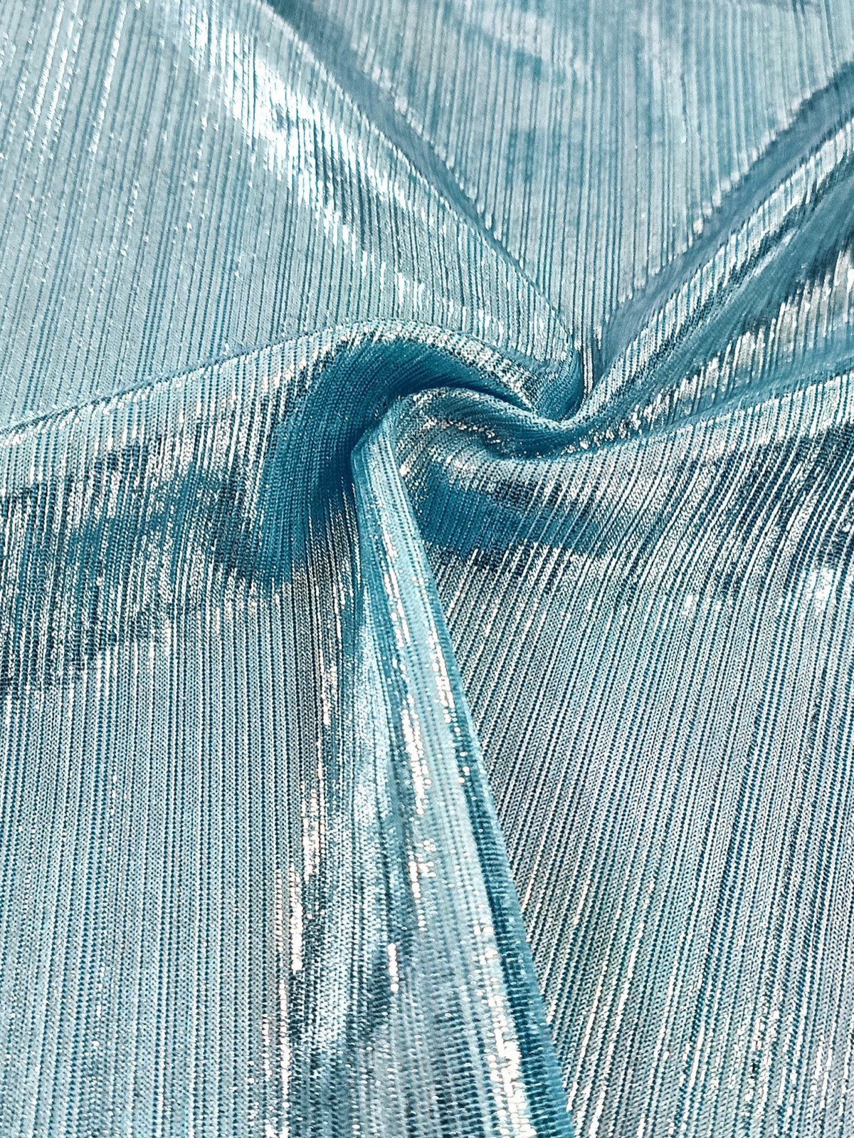 Metallic fabric detail of an ice blue metallic off-shoulder maxi dress with a ruched buckle waist.