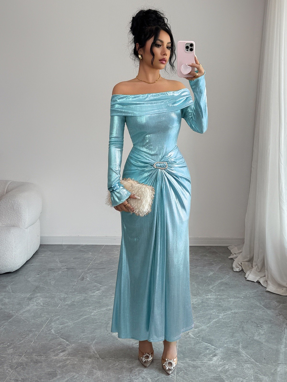 Mirror lifestyle view of an ice blue metallic off-shoulder maxi dress with a ruched buckle waist.