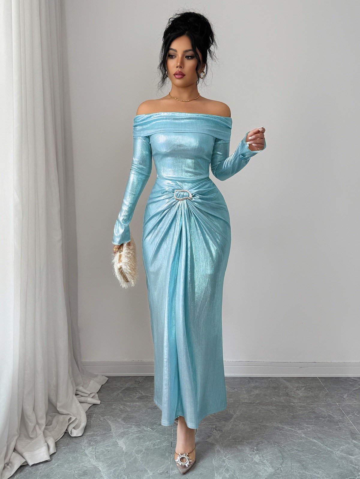 Primary front view of an ice blue metallic off-shoulder maxi dress with a ruched buckle waist.