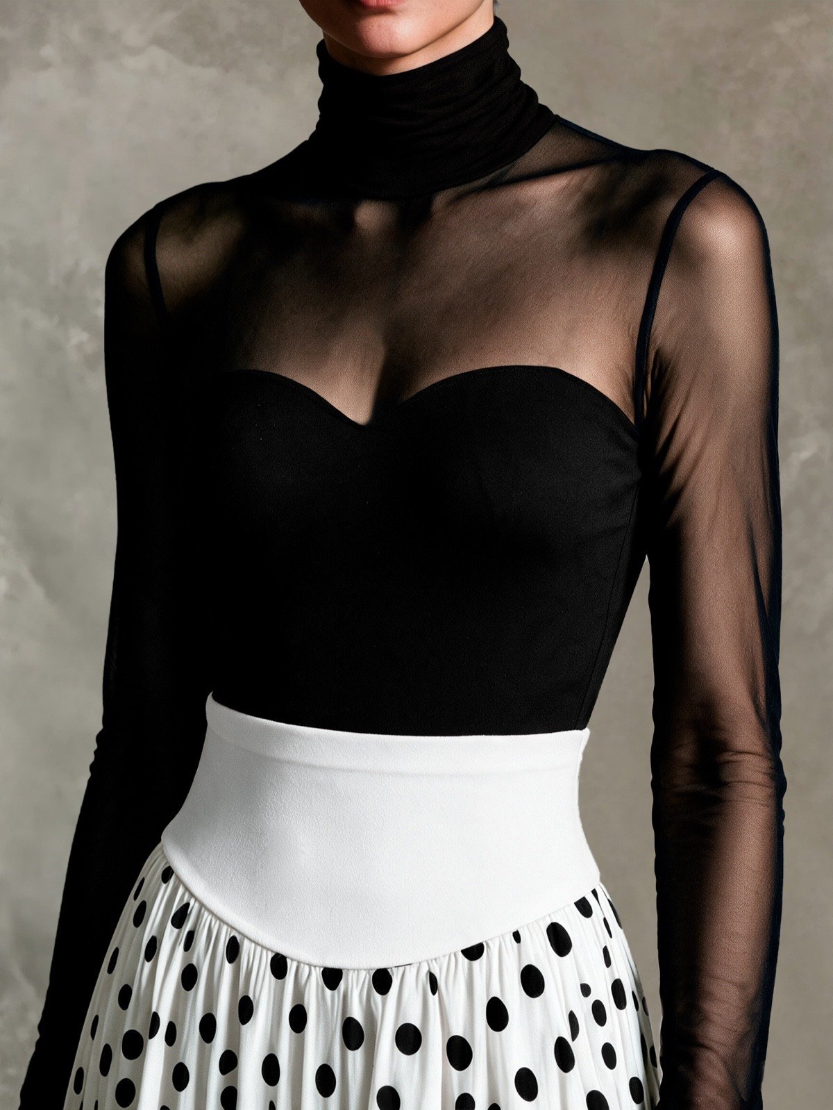 High neckline close-up of a black sheer mesh top and white polka-dot full-circle maxi skirt set.