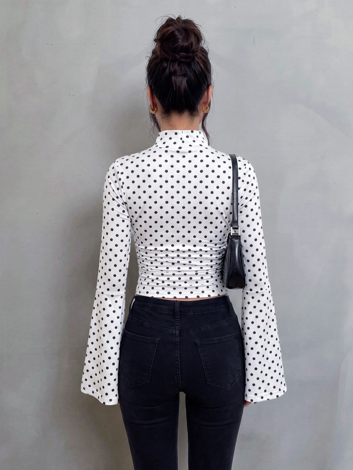 Crop top back view of a white polka-dot bell-sleeve crop top and matching pants set.