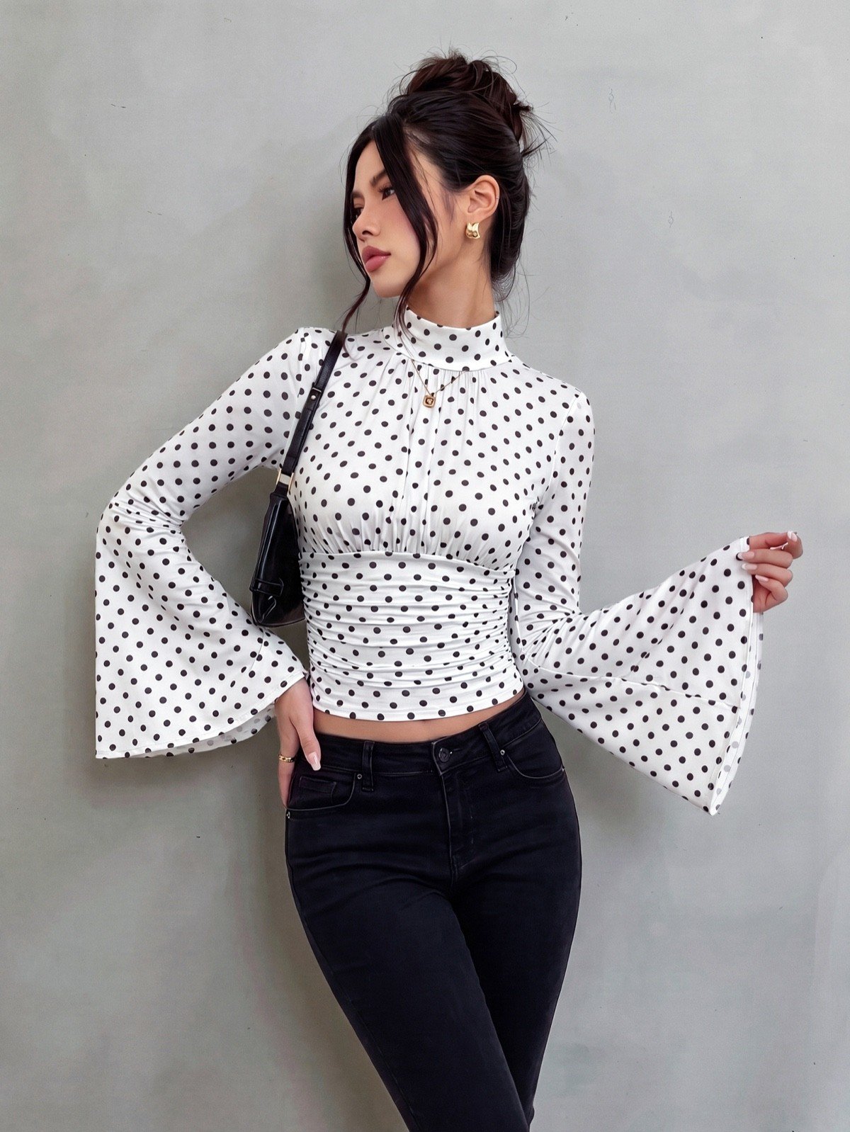 Crop top front view of a white polka-dot bell-sleeve crop top and matching pants set.