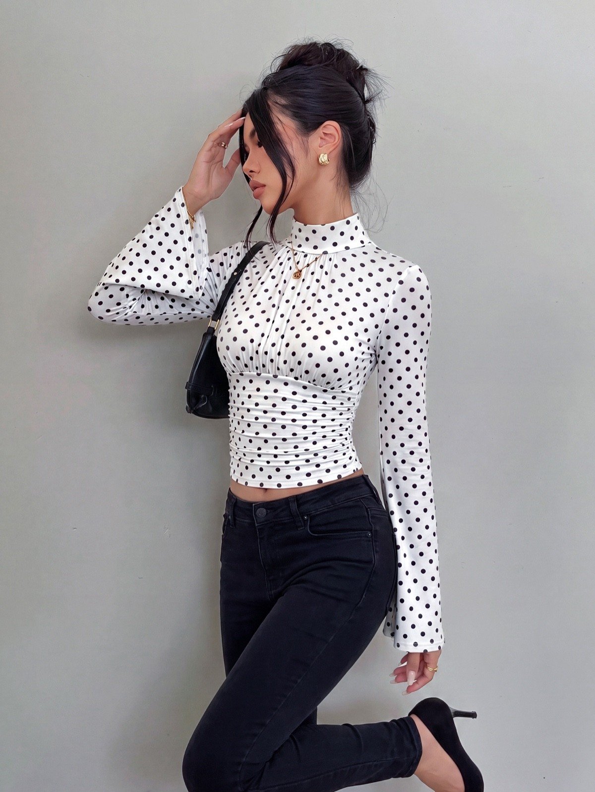 Crop top side view of a white polka-dot bell-sleeve crop top and matching pants set.