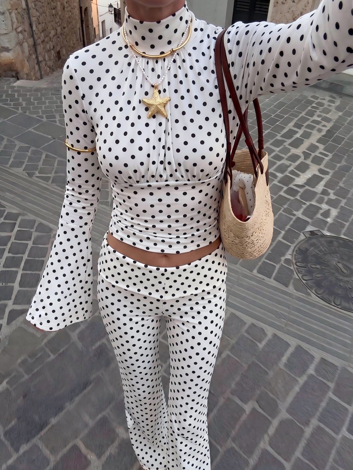 Primary set front view of a white polka-dot bell-sleeve crop top and matching pants set.