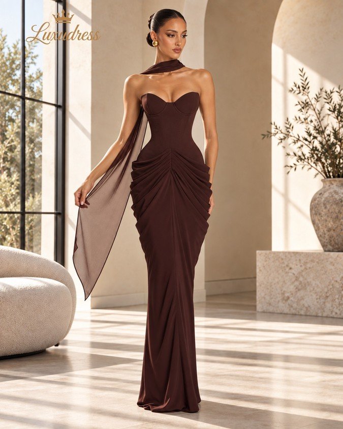 Front view of a chocolate brown strapless corset evening gown with shaped bust cups, fitted waist and ruched hip draping.