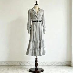 Dark gray ruffle V-neck tiered midi dress with long sleeves and layered ruffle skirt on dress form