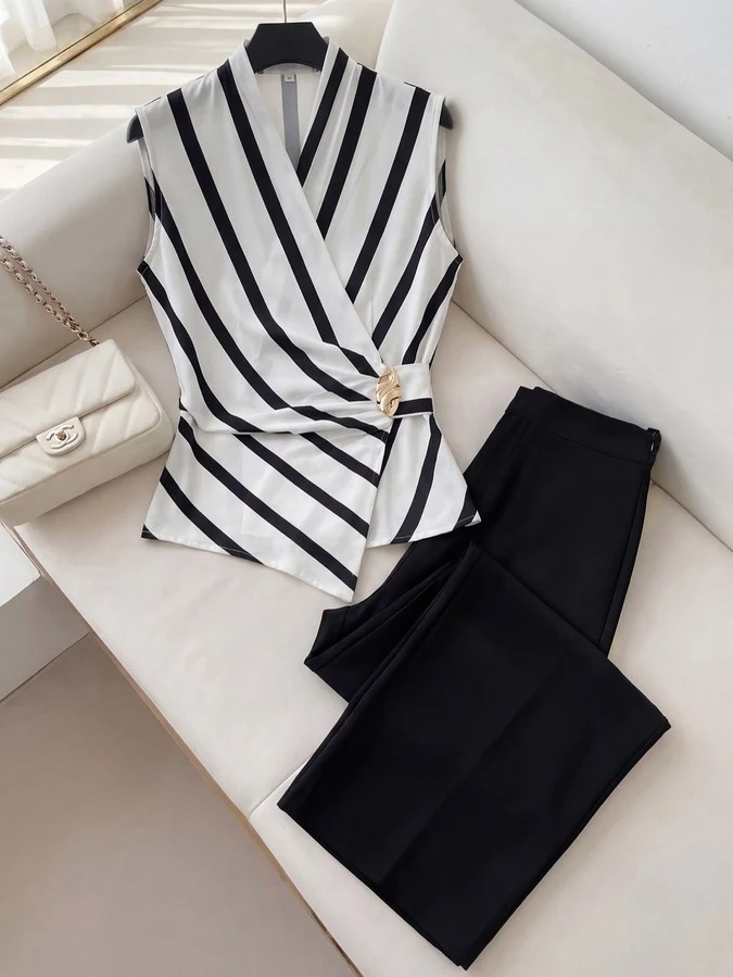 Primary set flat-lay of a striped wrap blouse and black wide-leg pants set with buckle detail.