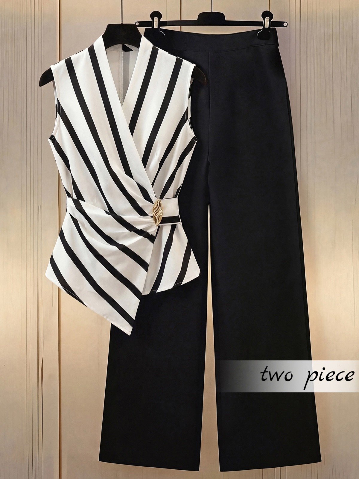 Hanger set display of a striped wrap blouse and black wide-leg pants set with buckle detail.