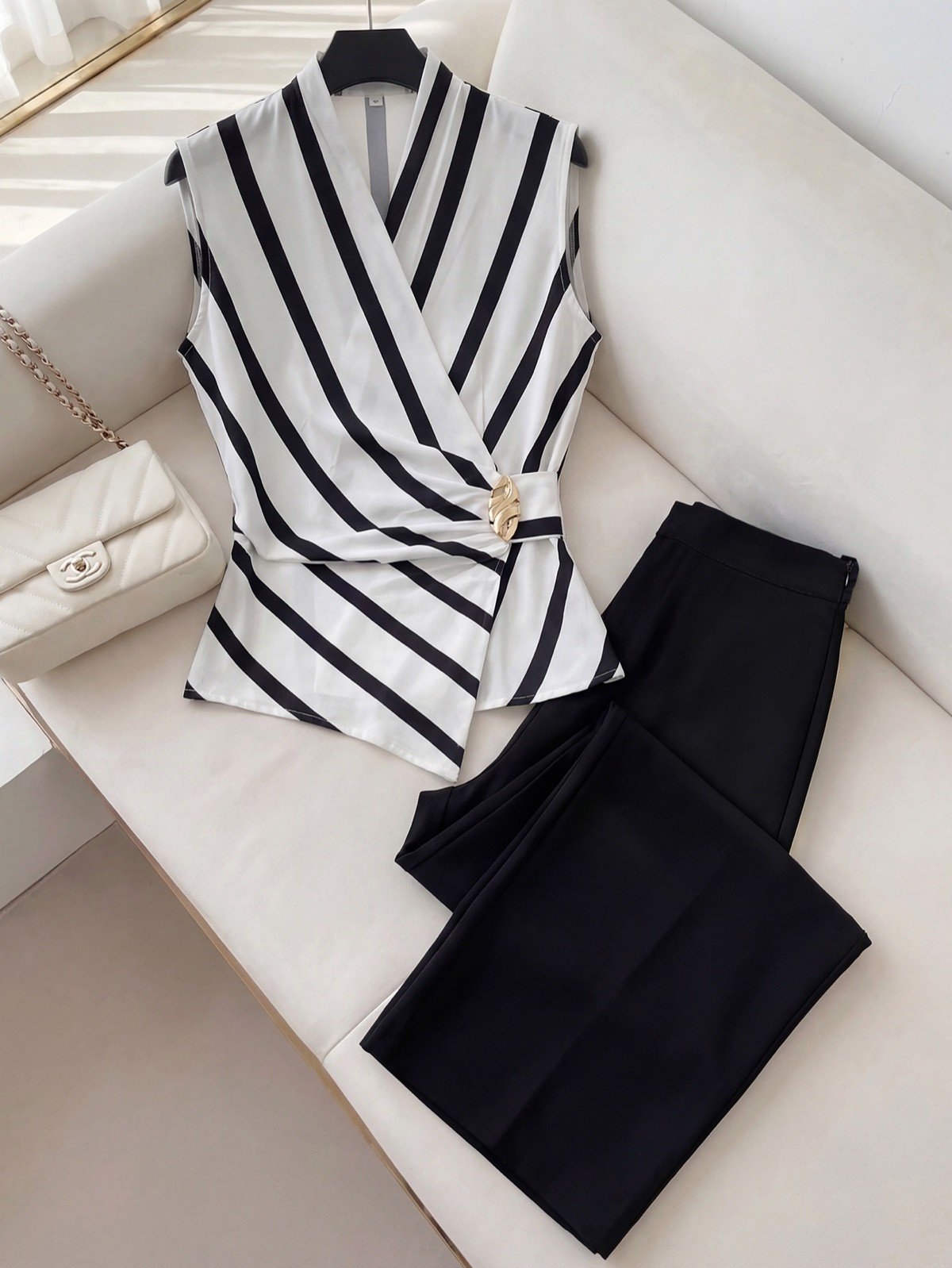 Striped Wrap Blouse and Pants Set – Primary Set Flat-Lay Primary set flat-lay of a striped wrap blouse and black wide-leg pants set with buckle detail.