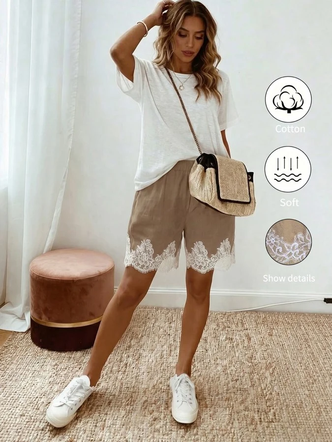 Lifestyle front view of taupe washed-cotton pull-on shorts with a white eyelash-lace hem.