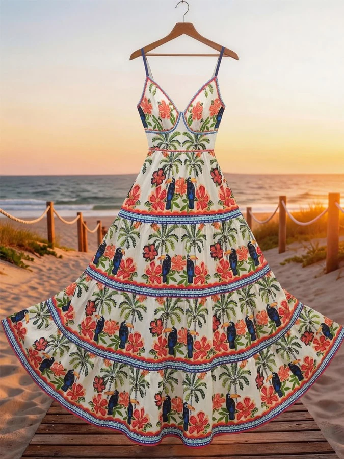 Hanger product display of a tropical print tiered maxi sundress with slim straps and a tie back.